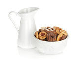 Various cookies in bowl and milk jug