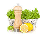 Lettuce in basket with lemons and pepper shaker
