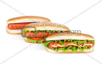 Three hot dogs with various ingredients