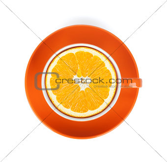 Ripe orange in tea cup