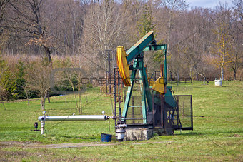Oil pump in green nature