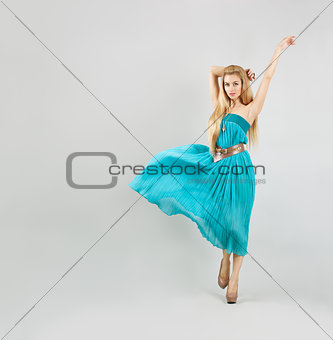 Woman in Turquoise Dress on Gray Backgound