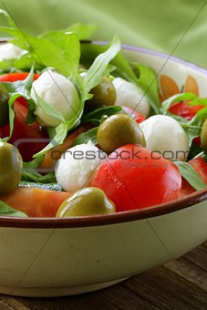 salad with arugula, tomatoes and mozzarella cheese