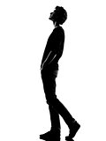 young man silhouette walking looking up