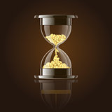 Hourglass with gold coins over dark background.