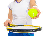 Closeup on female tennis player with racket and ball