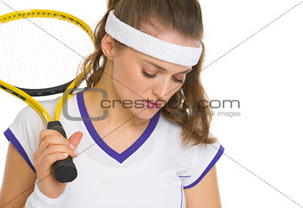 Portrait of concerned female tennis player with racket