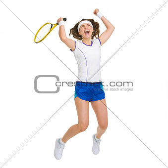 Happy female tennis player jumping