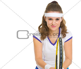Smiling female tennis player in stance
