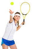 Female tennis player serving ball