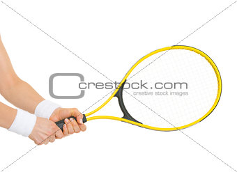 Closeup on hand of female tennis player holding racket