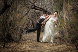 Newlyweds Playing in Forest