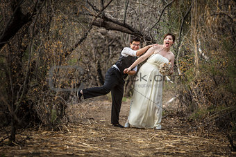 Newlyweds Playing in Forest