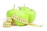 Green apples and measuring tape isolated on white background