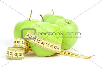 Green apples and measuring tape isolated on white background