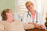 Doctor or Nurse Talking to Sitting Senior Woman