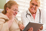 Doctor or Nurse Talking to Senior Woman with Touch Pad