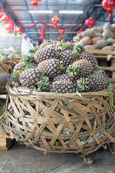Pile of Pineapples in Big Basket