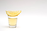 Tequila shot with lemon wedge