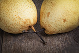two asian pears on old wooden table