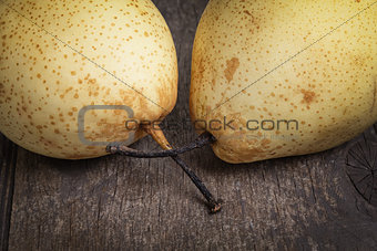 two asian pears on old wooden table