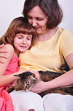 grandmother and granddaughter with their cat