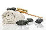 Spa setting with massage stones, brush and a towel