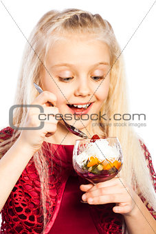 Beautiful blond girl eating dessert