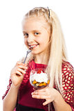 Beautiful blond girl eating dessert