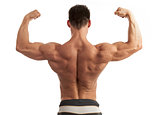 Rear view of a young man flexing his arm and back muscles over white