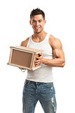 Muscular young man holding parcel over white