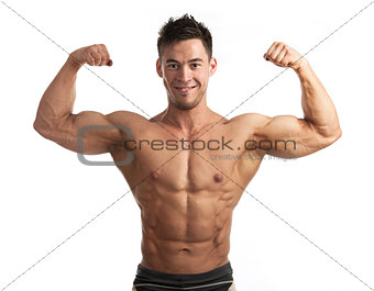 Waist-up portrait of muscular man flexing his biceps against white background