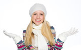Smiling girl in winter clothes catching snow