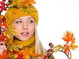 Girl in hat and scarf with autumn bouquet looking on copy space