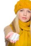 Closeup on girl holding pills pack