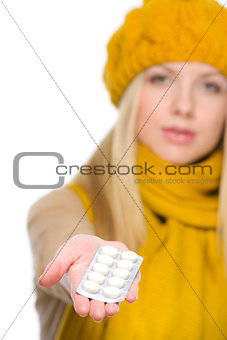 Closeup on girl holding pills pack