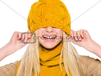 Smiling girl in autumn clothes with hat over head
