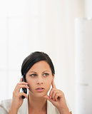 Concerned young woman talking mobile phone