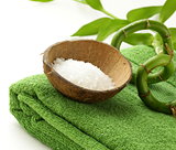 branch of bamboo, sea salt and towel - green spa concept