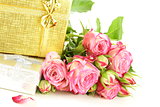 pink roses and box with gifts on a white background