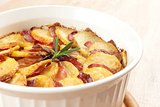 potato casserole with rosemary twig