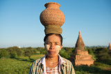 Portrait of Asian traditional farmer carrying pot on head