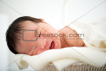 Newborn Asian baby girl smiling