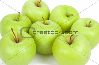 seven green apples isolated on a white background 