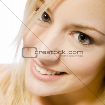 Studio portrait of a young blond woman smiling
