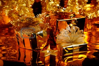 Gold Christmas decoration with boxes and candle