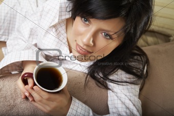 young woman is having her morning tea