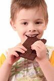 The boy eats a greater chocolate