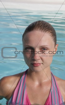 Beautiful young woman in the pool