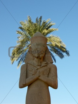 Statue with hair from palm leaves in Karnak temple
